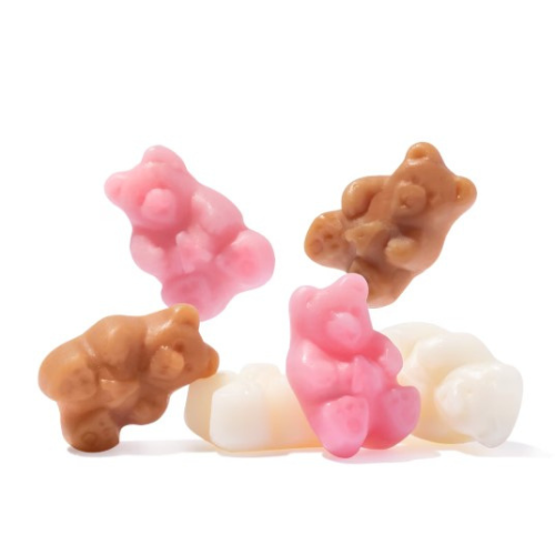 Four bear-shaped candies in pink, brown, and white on a white background