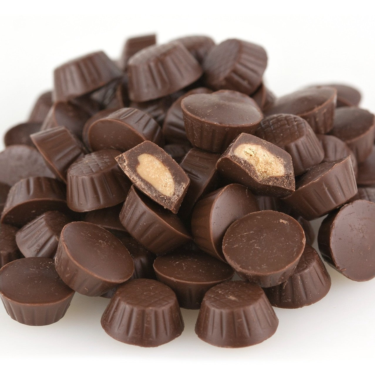 Pile of chocolate cups on a white background
