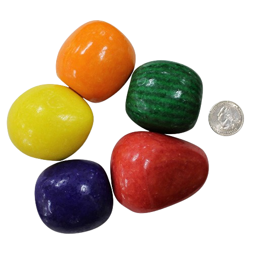 Five colorful fruit gumballs of different sizes and colors on a white background with a coin for scale.