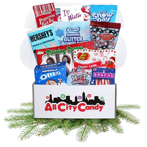 Curated box of Winter theme candy in colorful box sitting on pine bough